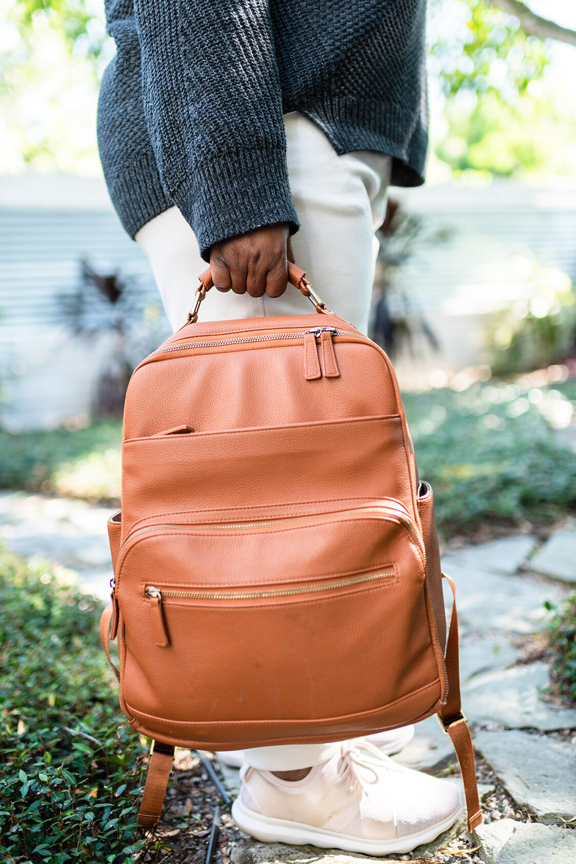 child holding a backpack